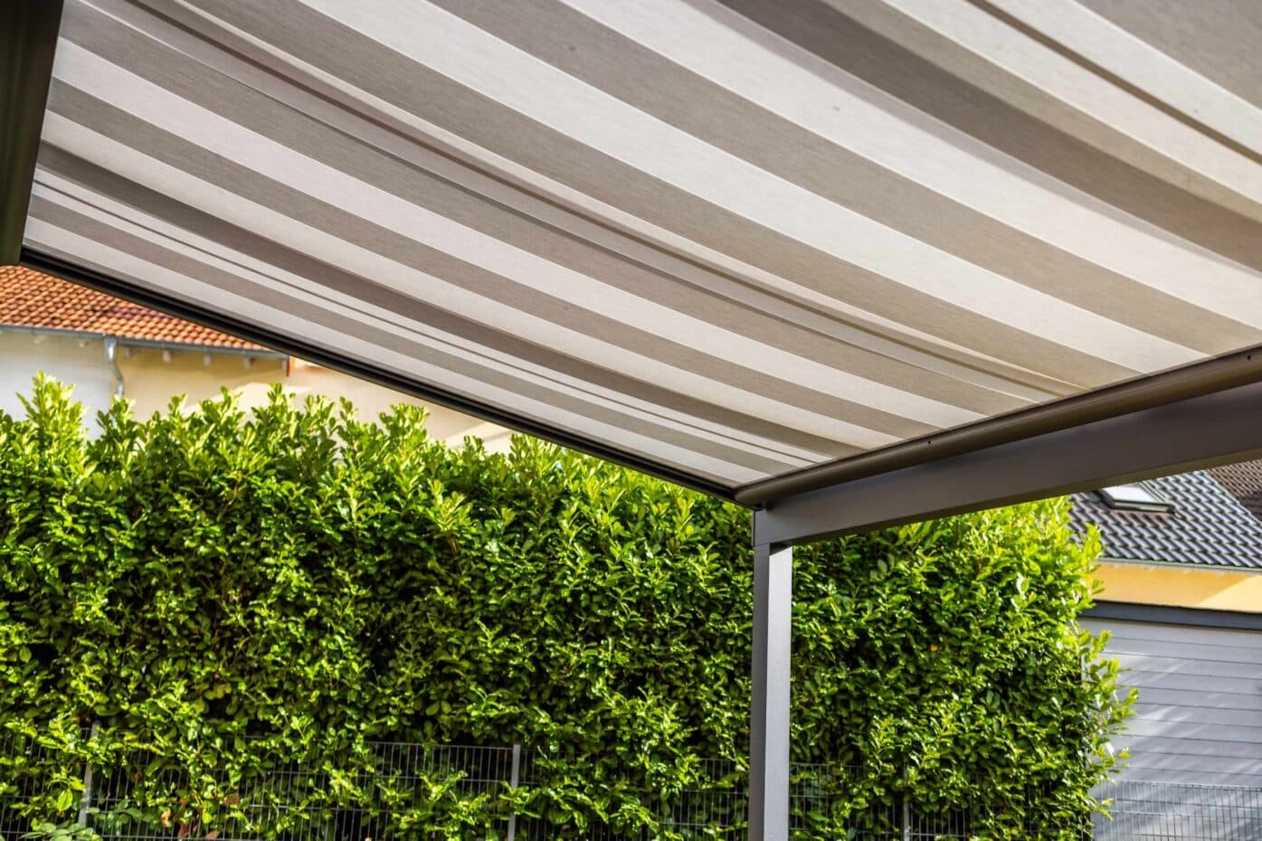 A patio featuring a canopy overhead and external blinds for shade and privacy.