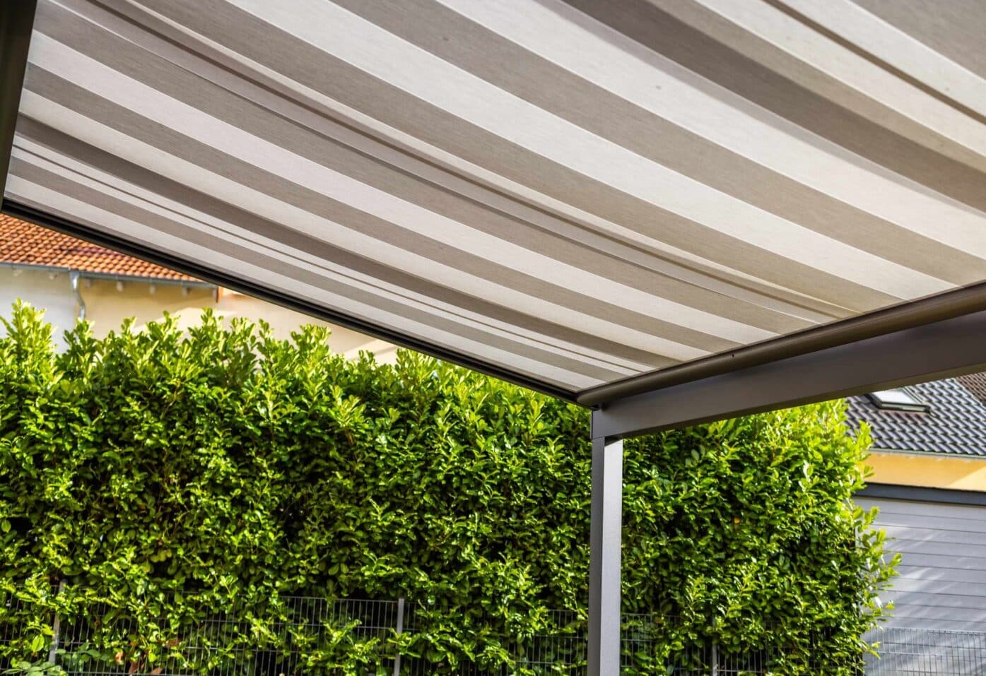 A patio featuring a canopy overhead and external blinds for shade and privacy.
